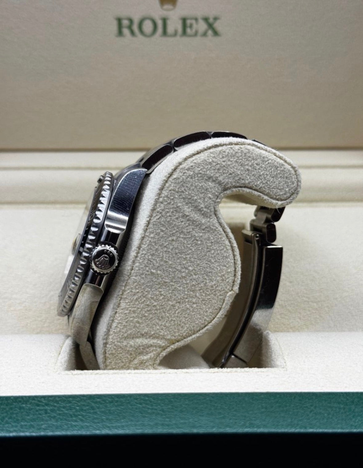 Rolex watch in a box with 'Rolex' branding visible