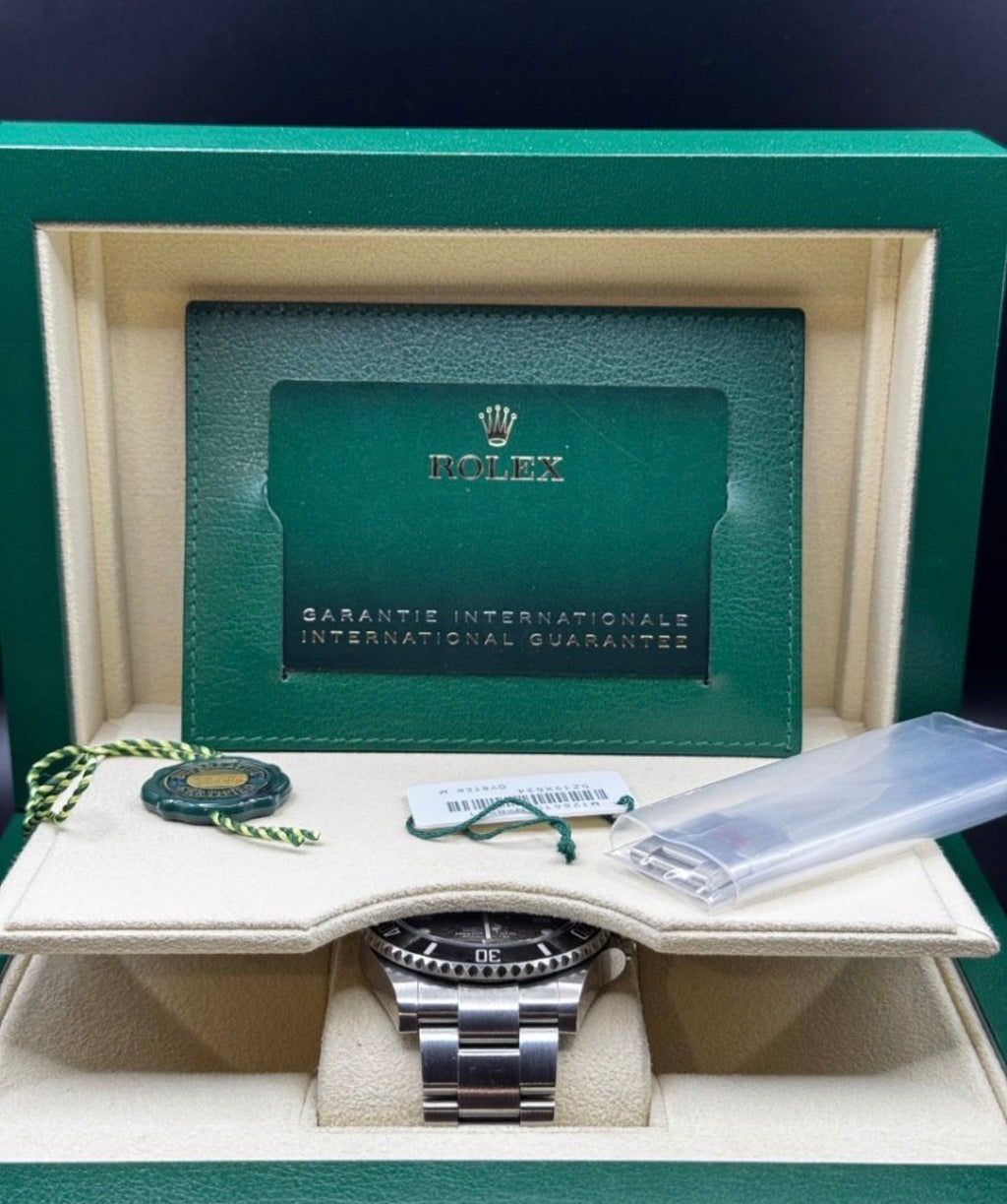 Rolex watch in a green box with a guarantee card